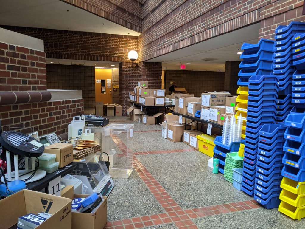 boxes of lab equipment line the edges of a brick atrium