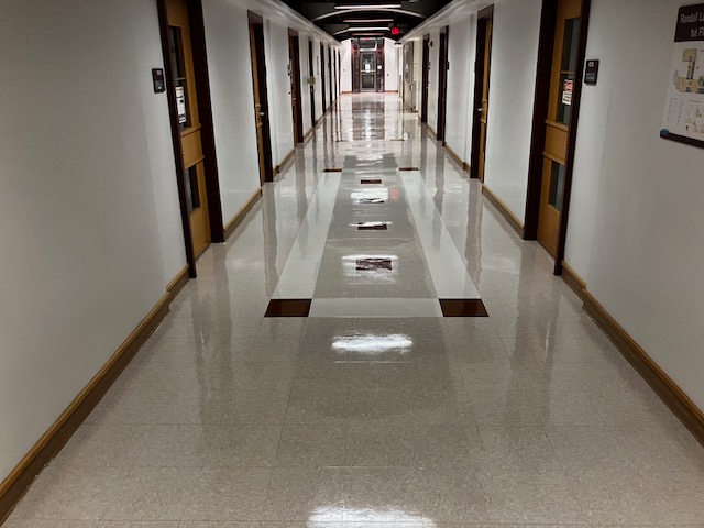 Shiny linoleum floors in a hallway with many doors